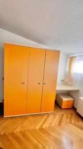 an orange cabinet in a room with a wooden floor at Miru Loft Prague in Prague +53 photos