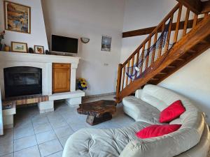 a living room with a couch and a fireplace at Maison abelias soustons plage in Soustons