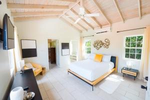 a bedroom with a bed and a living room at Sweet Home Grenada Caribbean in Lance aux Épines
