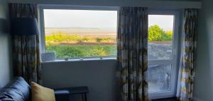 a large window with a view of a field at Ivy's in Grange Over Sands