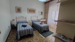 a bedroom with two beds and a window at Fabia's House in Tertenìa