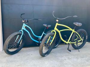 two bikes are parked next to a wall at Hotel Perico Azul & Surf Camp in Jacó