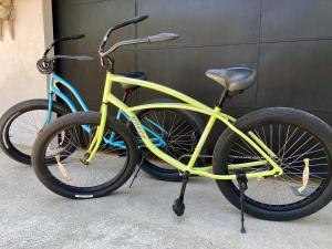 two yellow bikes parked next to each other at Hotel Perico Azul & Surf Camp in Jacó