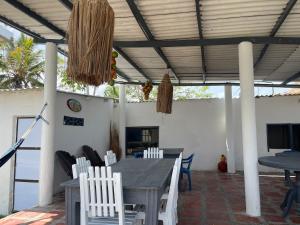 a patio with a table and chairs and a television at Palmarena in Puerto Viejo