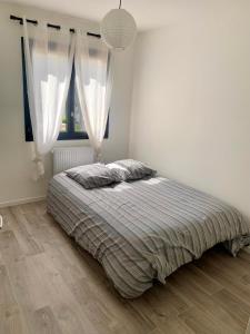 a bedroom with a bed and a large window at 5mn Crolles Chambre au calme parking gratuit - belle cuisine partagée in Froges