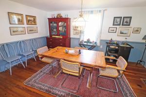 a dining room with a wooden table and chairs at Blue Point - Pet friendly with Outdoor shower! in Chincoteague +17 photos
