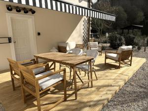 a wooden table and chairs on a wooden deck at GURAH Boutique Apartments in Bakio