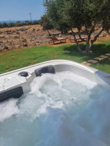 a jacuzzi tub filled with water in a yard at Agros simple living in Frangokastello