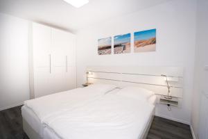 Postel nebo postele na pokoji v ubytování Strandburg 4