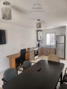 a kitchen with a table and chairs in a room at Daher Apartment Homes in La Consulta