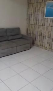 - un salon avec un canapé et un sol blanc dans l'établissement Casa Fundos na Enseada - 2 Quartos, à São Francisco do Sul 1 autre photo