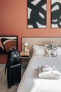 a bedroom with a bed and a suitcase at Studio 2 - Gorgeous studio in Earls Court in London