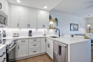 a kitchen with white cabinets and a sink at 2003 Costa Del Mar Road - Unit 676 in Carlsbad +28 photos