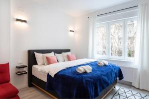 a bedroom with a bed with two towels on it at Lux Nest II City Apartment URBAN STAY in Zagreb