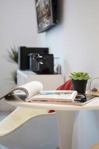 a white table with a phone and books on it at Lux Nest II City Apartment URBAN STAY in Zagreb