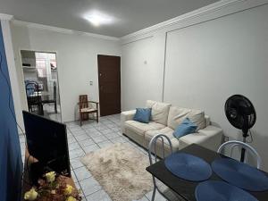 a living room with a couch and a table at Apartamento em Natal-RN in Natal +11 photos