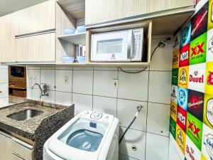 a small bathroom with a toilet and a microwave at Apê Confortável I Wi-Fi e A/C in Imperatriz +18 photos