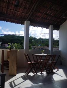 a table and two chairs on a balcony with a view at La Belle Pipa in Pipa