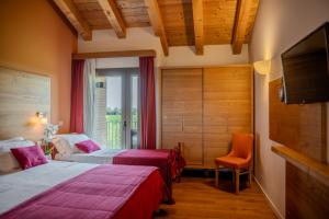 a hotel room with two beds and a television at Borgo Ronchetto in Salgareda +82 photos