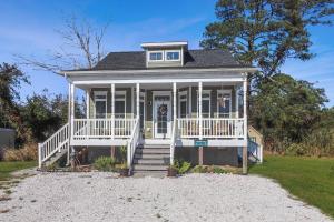 a small house with a white porch and stairs at Cockleshell Cottage - Pet friendly & Handicap Accessible! in Deep Hole