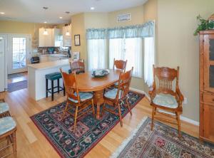 a kitchen and dining room with a wooden table and chairs at Cockleshell Cottage - Pet friendly & Handicap Accessible! in Deep Hole