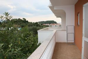 a balcony with a view of the countryside at Apartments Sandra in Rab