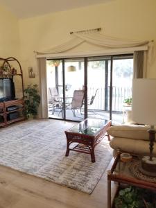 a living room with a couch and a glass table at Island Life in Saint Augustine Beach