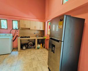 a kitchen with a stainless steel refrigerator in a room at Sierra Bonita in Santa Marta