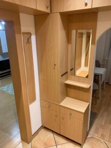 a large wooden cabinet with a mirror in a room at Your home 10 with parking in Košice +15 photos