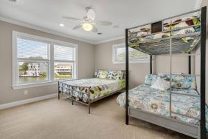 a bedroom with two bunk beds and a bed at Diving Duck - Waterfront home w Hot tub & Boat dock & King Bed in Greenbackville +75 photos