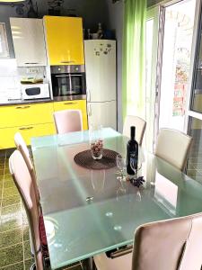 a kitchen with a table with wine glasses on it at Apartmani Ferri 1 in Vrbanj