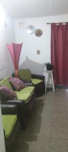 a living room with two couches and a red curtain at Casa de la Nona in Cordoba