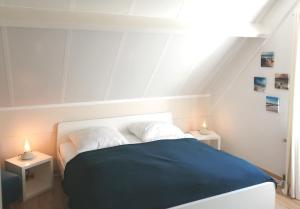 a bedroom with a bed with two night stands at Ferienhaus 2004 in Tossens in Tossenserdeich