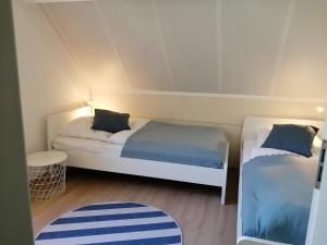 a room with two beds and a rug at Ferienhaus 2004 in Tossens in Tossenserdeich +27 photos