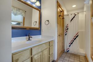 a bathroom with a sink and a mirror and a shower at Egret's Cove - Pet friendly w/ Hot tub! in Deep Hole +42 photos