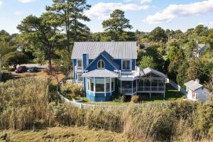 an aerial view of a blue house at Egret's Cove - Pet friendly w/ Hot tub! in Deep Hole