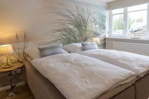 Ένα ή περισσότερα κρεβάτια σε δωμάτιο στο Wohnung am Binnensee