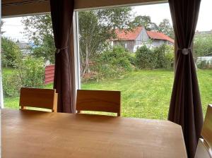 a table with two chairs and a large window at Ferienhaus Stefanie in Bernbeuren +2 photos