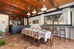 a dining room with a long table and chairs at Villa Le Cicale in Montecatini Val di Cecina