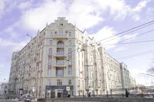 a large white building on the corner of a street at Ars Hotel on Krasnie Vorota in Moscow