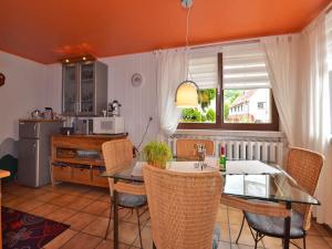 a kitchen with a table and chairs in a room at Wohnung Steinbach nahe Skihalle Oberhof in Kurort Steinbach-Hallenberg