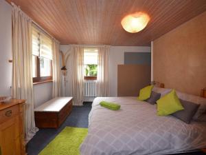 a bedroom with a large bed with green pillows at Wohnung Steinbach nahe Skihalle Oberhof in Kurort Steinbach-Hallenberg