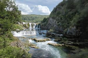 a waterfall in the middle of a river at Seosko domacinstvo Halil & Alema in Ćukovi