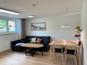 a living room with a couch and a table at Haus Ostwind - Wohnung 3 in Dahme