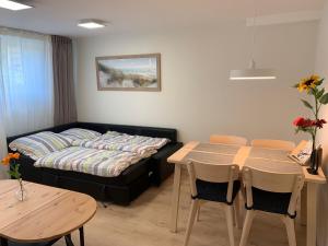 a living room with a bed and a table and chairs at Haus Ostwind - Wohnung 3 in Dahme +38 photos