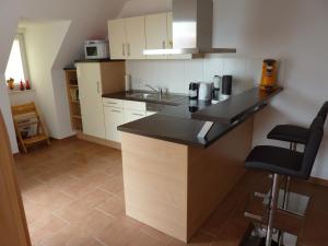 a kitchen with a black counter top in a room at Ostseebrise 14 - Großenbrode in Grossenbrode
