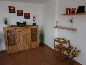 a room with a wooden cabinet and a shelf at Ostseebrise 14 - Großenbrode in Grossenbrode