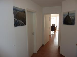 a hallway with two pictures on the walls of a room at Ostseebrise 14 - Großenbrode in Grossenbrode +19 photos