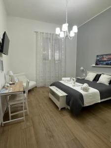 a bedroom with a large bed and a desk and a desk at Apulia White House 59 in Bari
