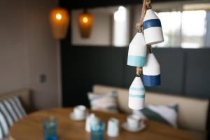 a toy boat hanging over a wooden table at Boje 73 in Scharbeutz +8 photos